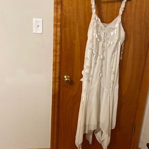 This dress is a  size 18 cream white with flowers printed in front